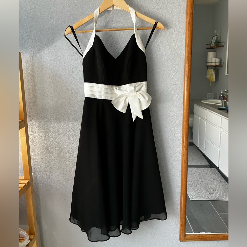 Halter neck black dress with white details and ribbon. Size 2. Used once.